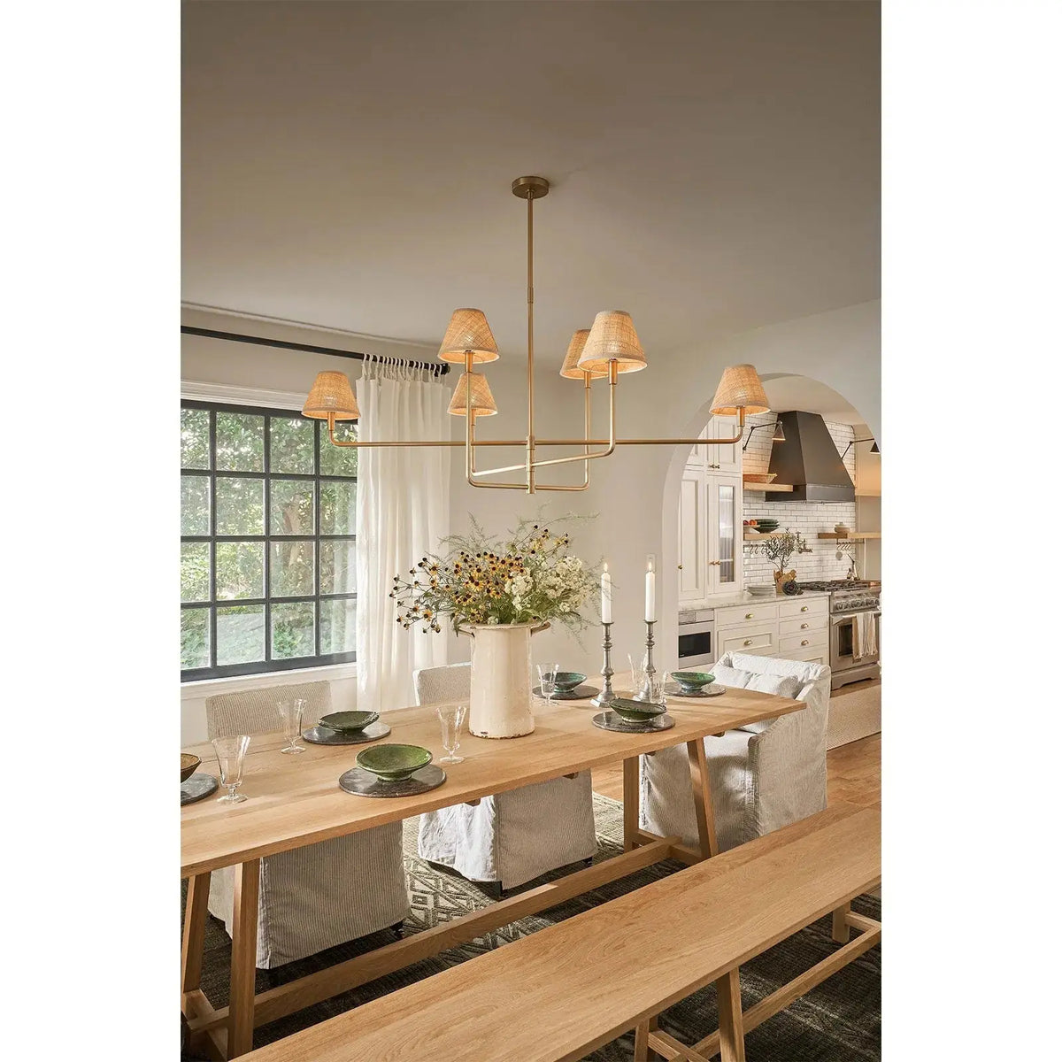Polly chandelier with natural brass arms and rattan shades