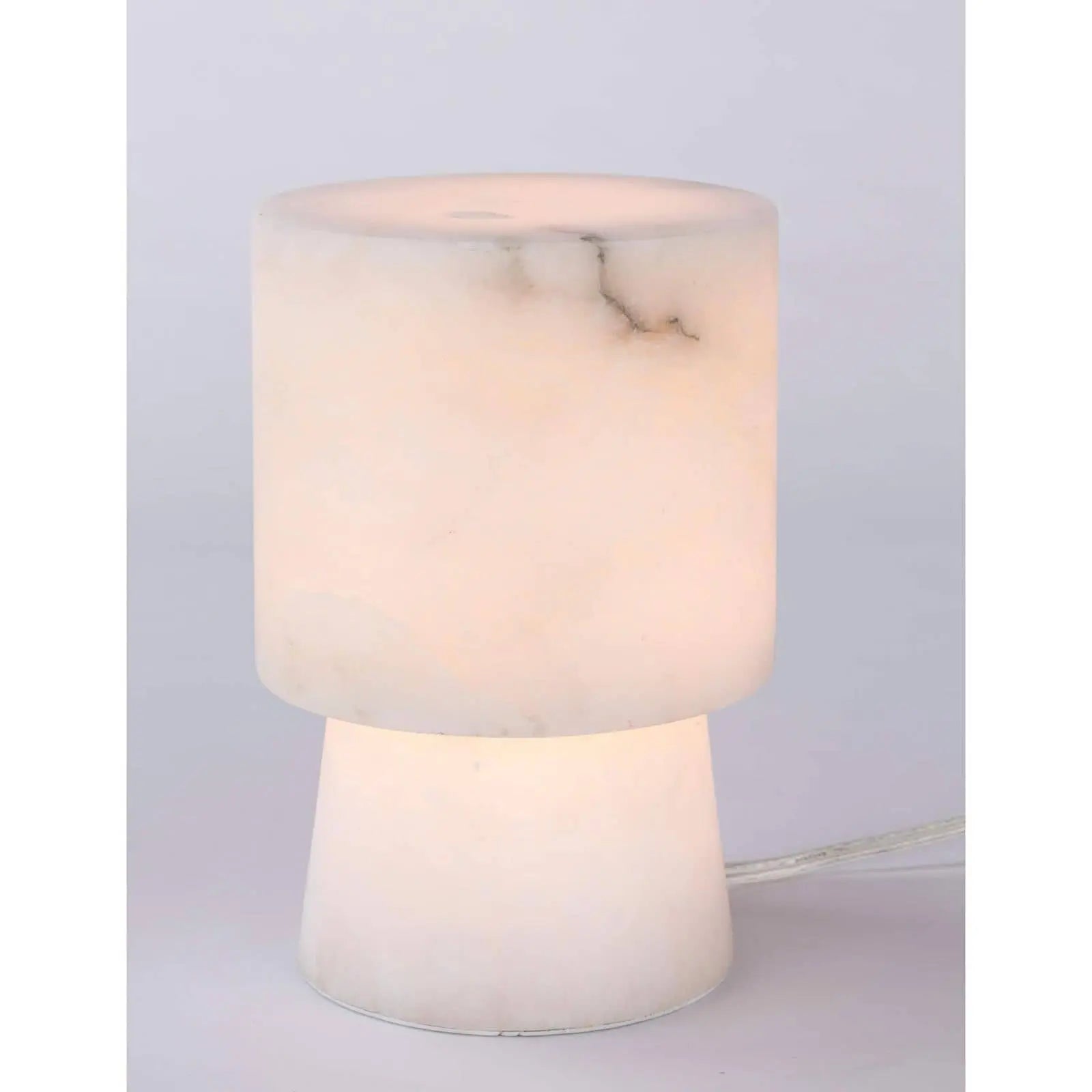 Hazel Alabaster Uplight, a small decorative lamp made from translucent natural alabaster stone, directing light upwards.