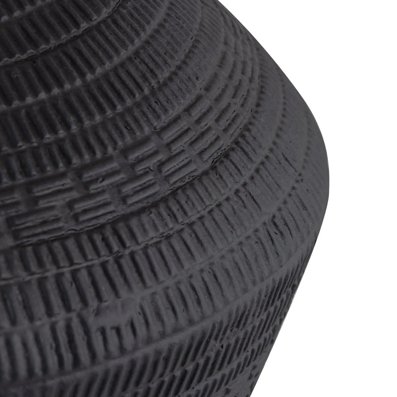 Close-up of a textured black lamp on a white background