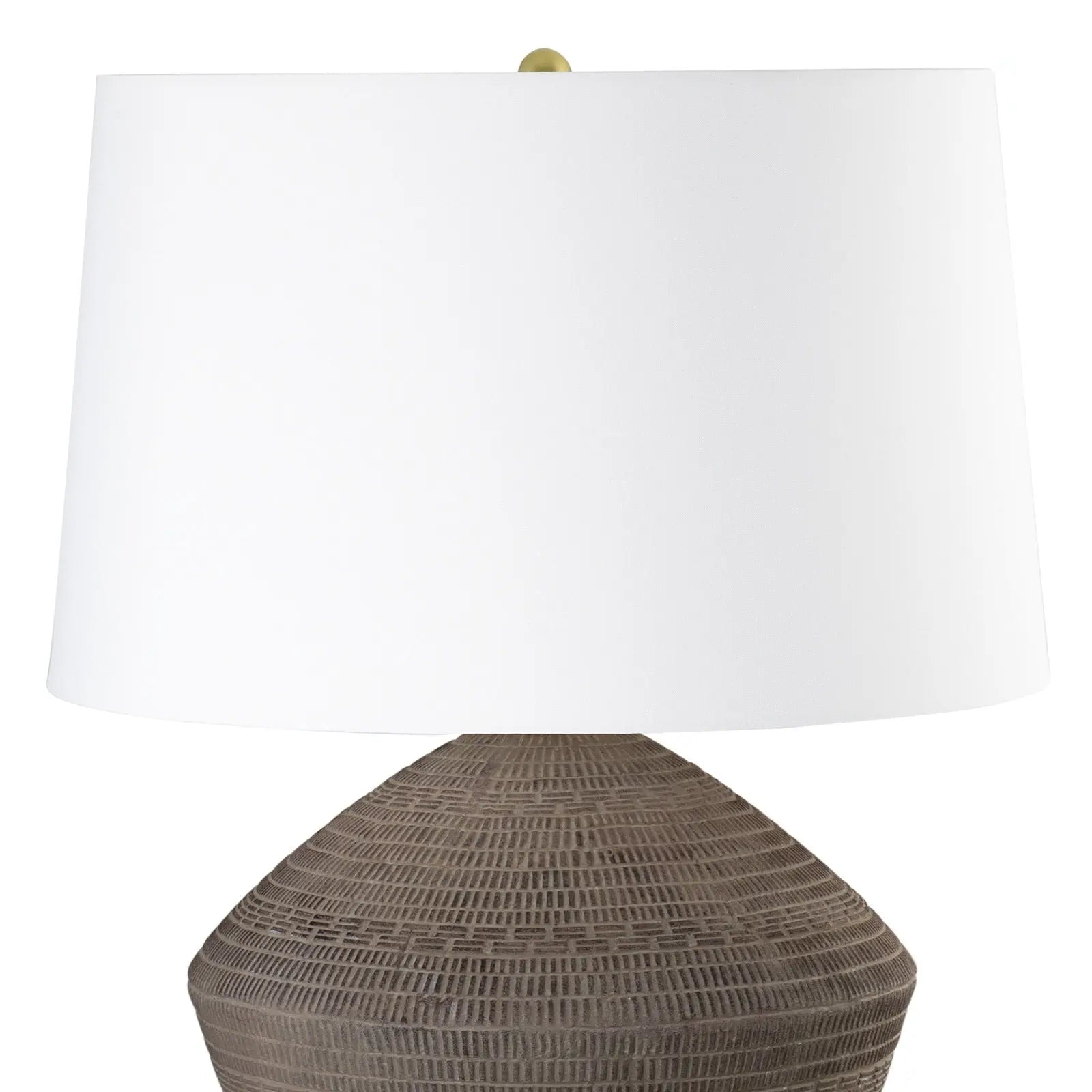 Table lamp with a textured brown base and white shade on a white background