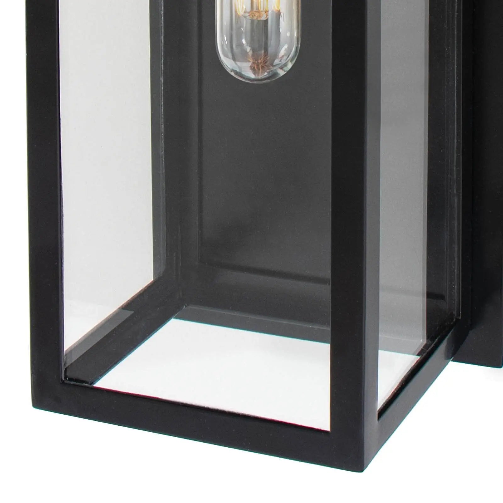Black outdoor wall light fixture with clear glass panels on a white background