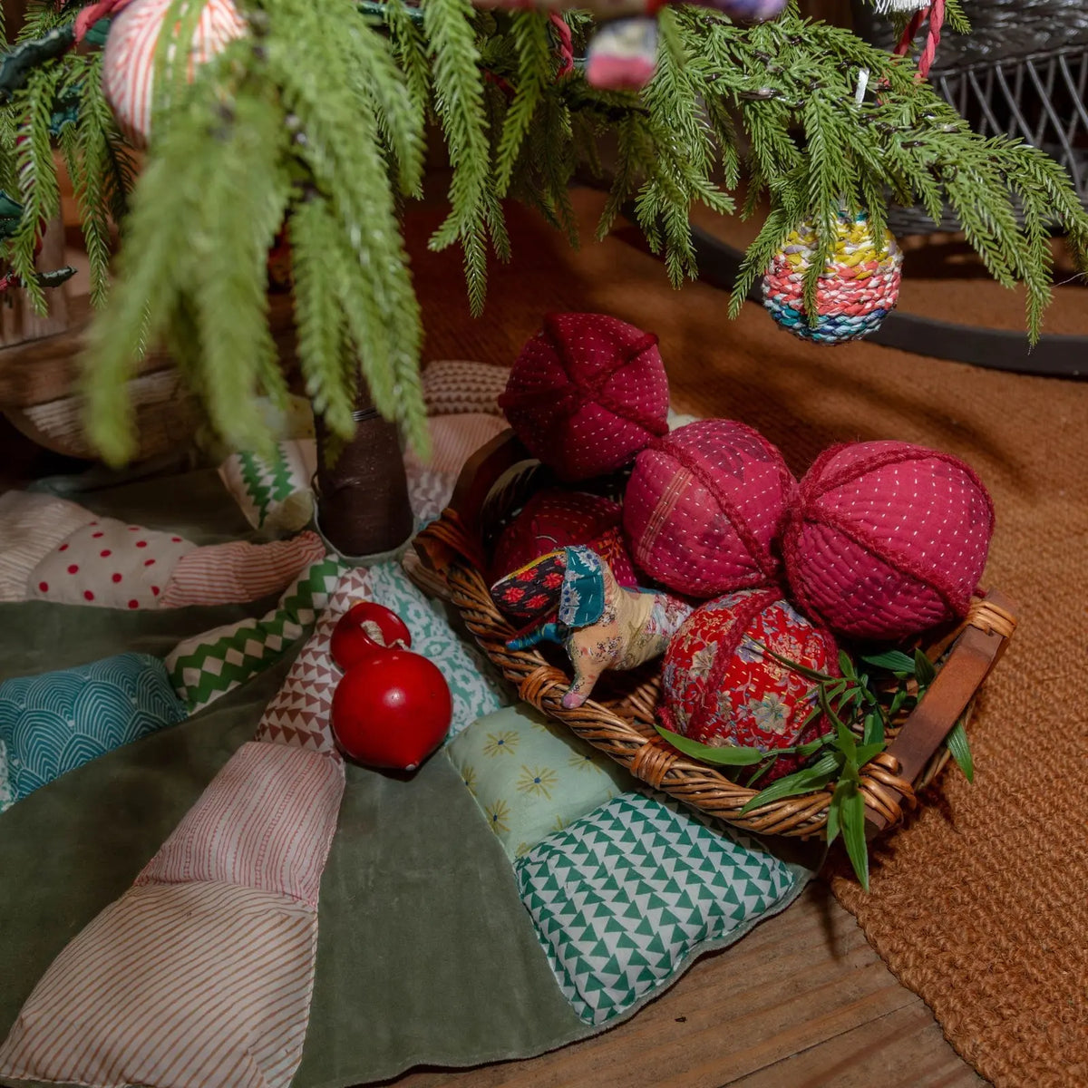 Close-up of the patchwork tree skirt with ornaments in a basket