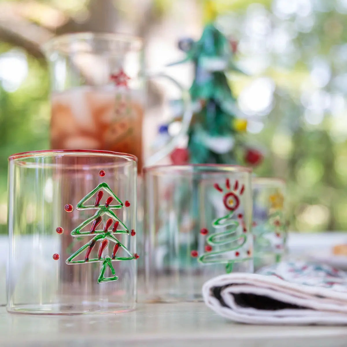 Christmas Tree Tumbler Set of 4 - festive glass tumblers with assorted Christmas tree designs for holiday entertaining and cocktails. Great hostess gifts.