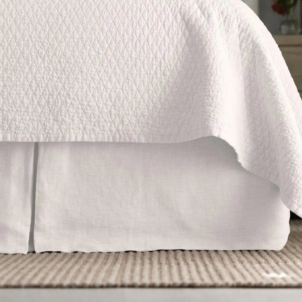 Dawn Tailored Bed Skirt in white, close-up on a bed frame