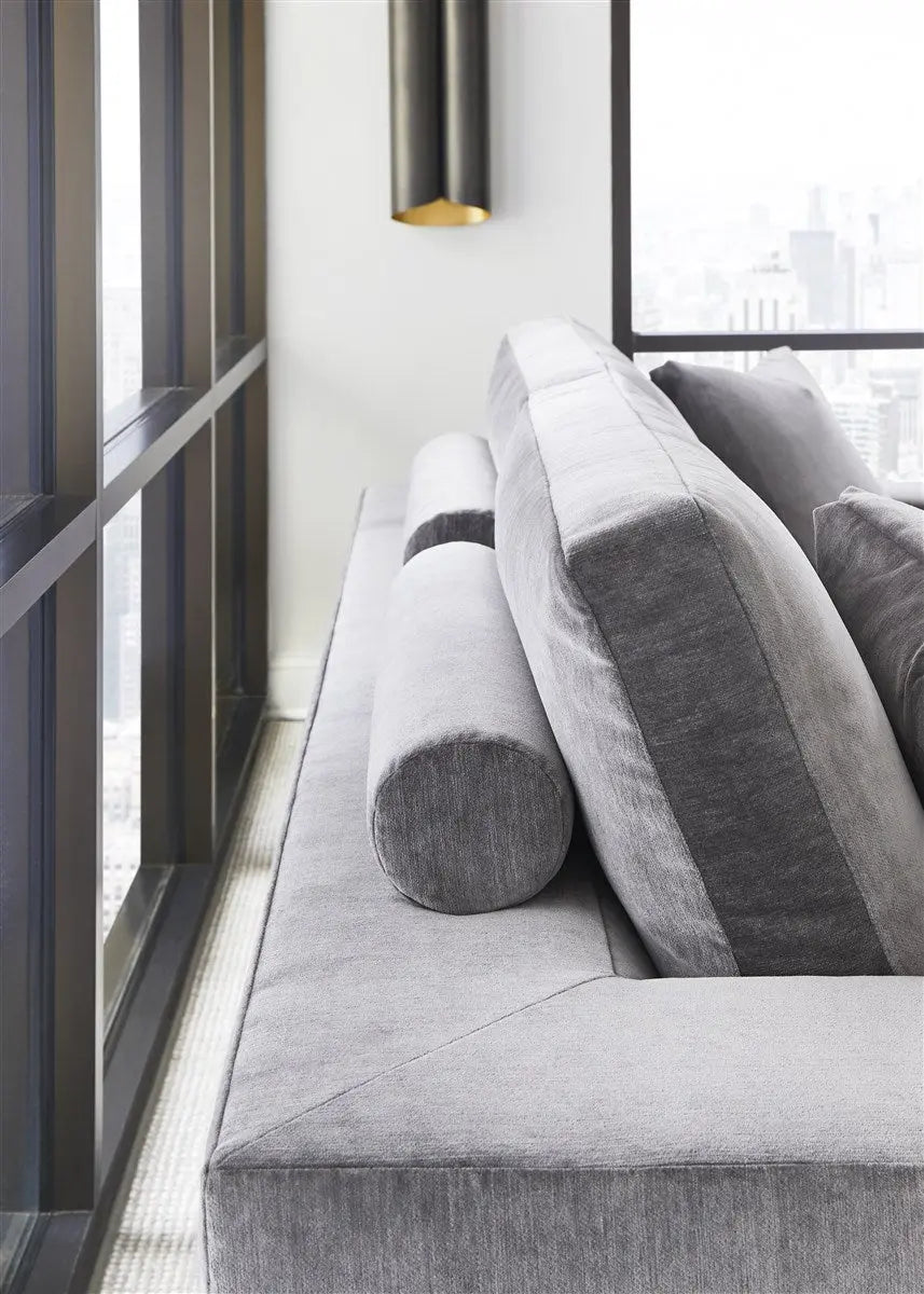 Gray sofa with decorative pillows in a modern interior setting