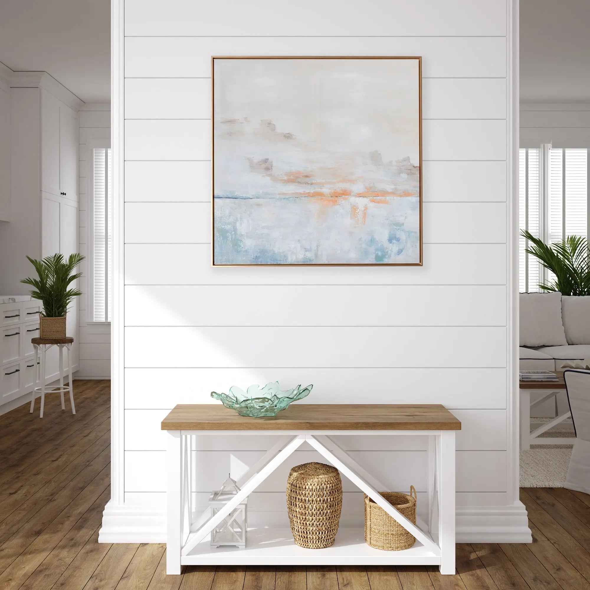 A square piece of wall art titled "After the Storm" showing a serene sky with soft, muted tones of blue, gray, and white, with hand-painted highlights, enclosed in a thin gold frame.