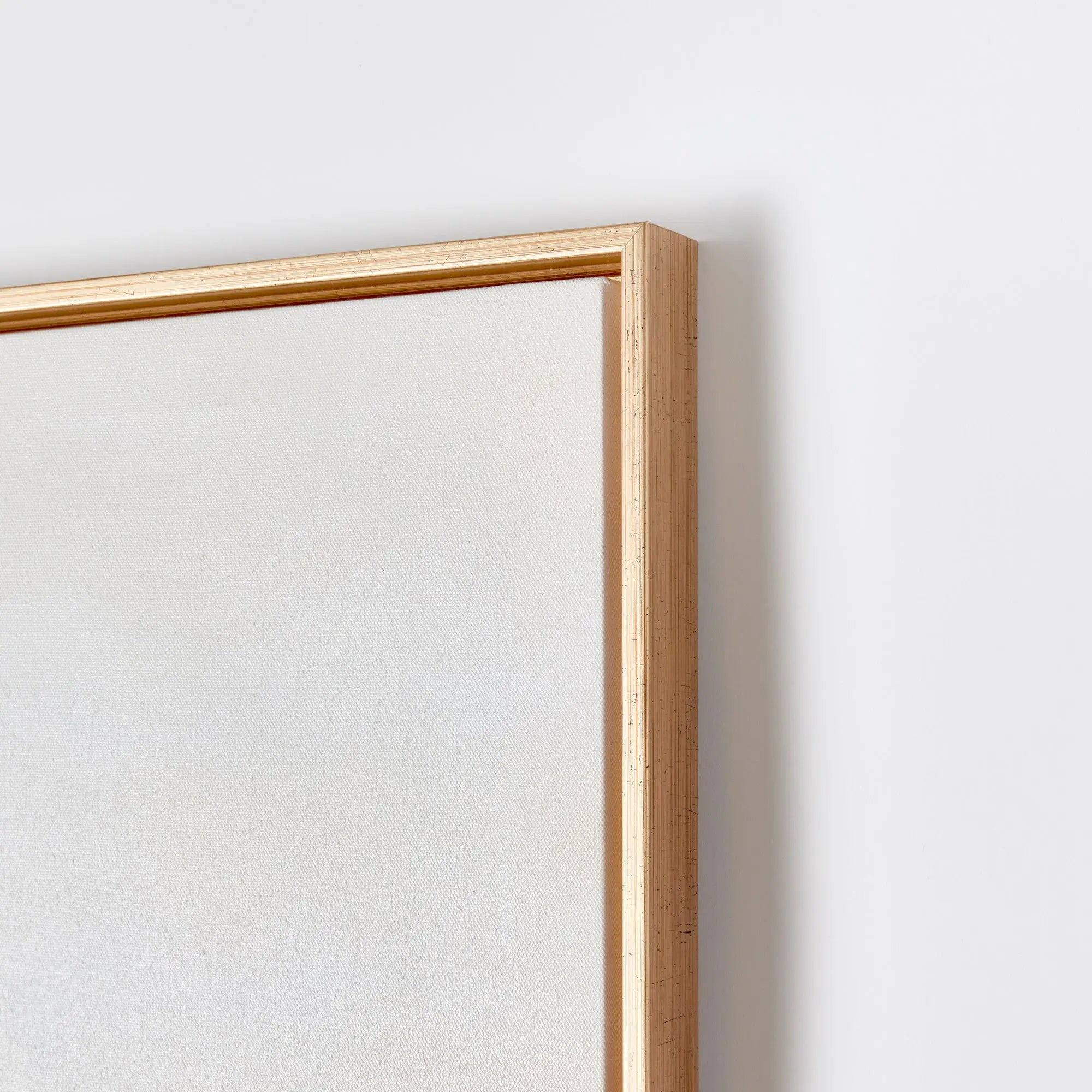 A square piece of wall art titled "After the Storm" showing a serene sky with soft, muted tones of blue, gray, and white, with hand-painted highlights, enclosed in a thin gold frame.