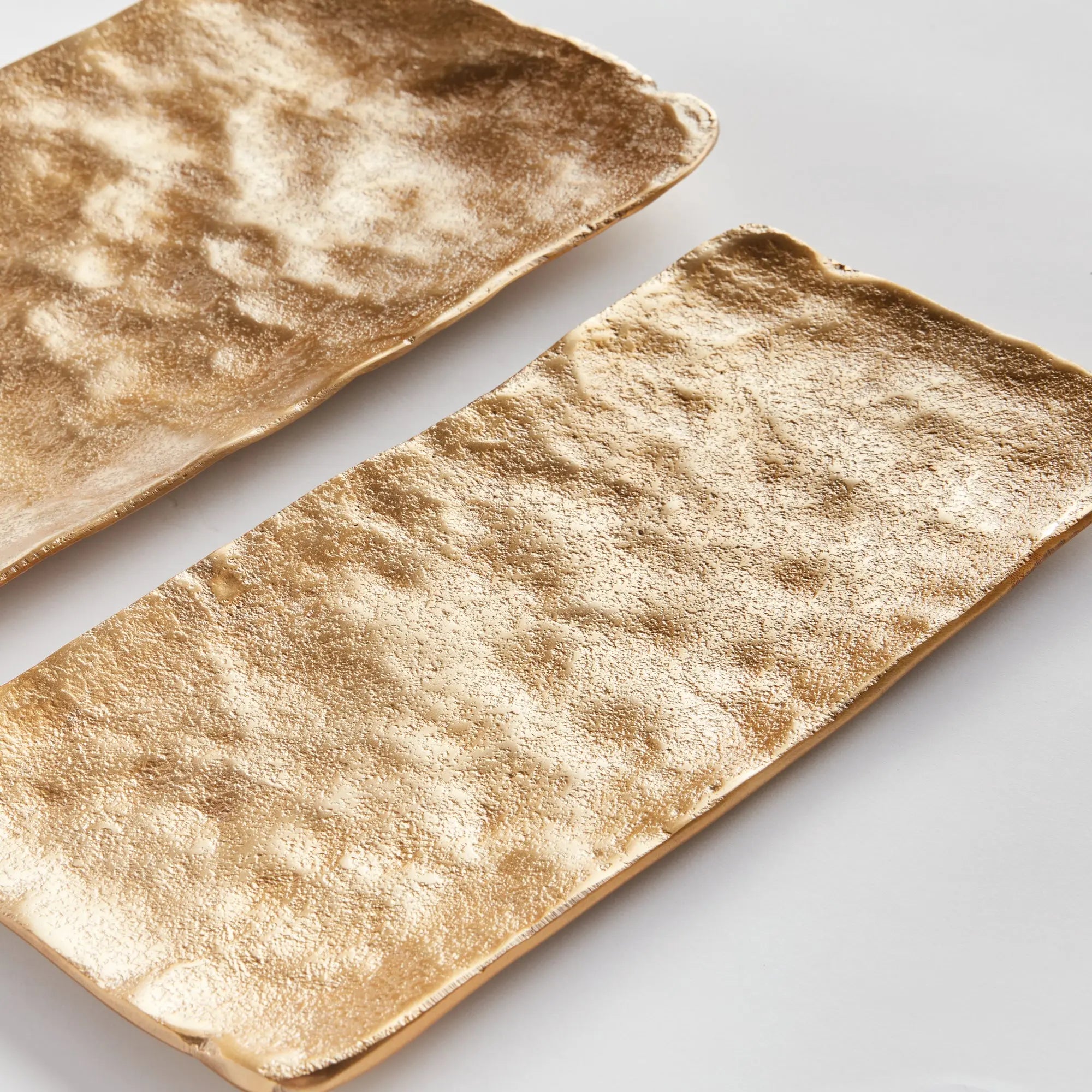 Imani Decorative Trays - modern gold cast aluminum trays with rounded edges, available in rectangular set of 2 or square set of 3