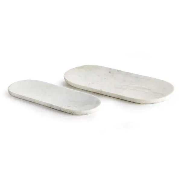 A set of two oval white marble trays, with a large and small tray displayed together, showcasing the unique natural veining in the stone.