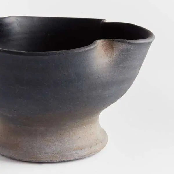 Kaloa Footed Decorative Bowl in a Small size, showing the matte black, hand-rubbed terracotta finish and the unique artisanal shape - Villa Decor & Design