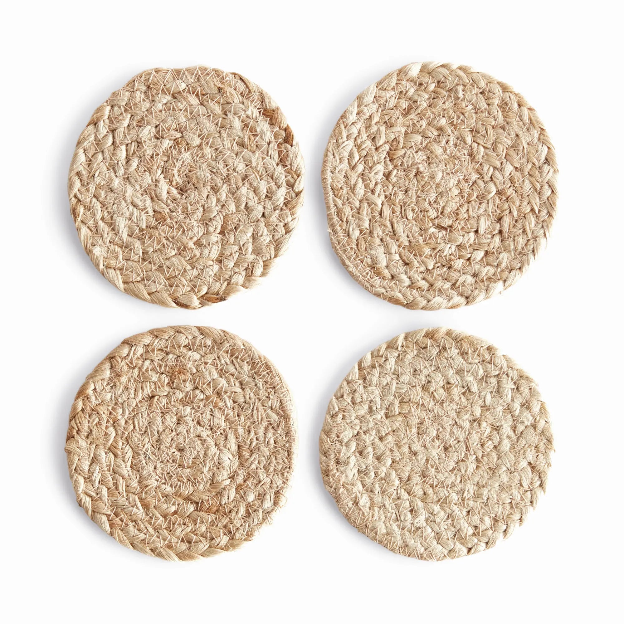 Four round woven coasters on a white background