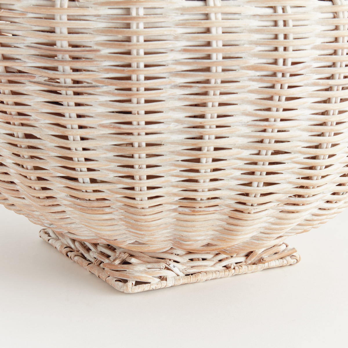Close-up of a woven wicker basket on a light background