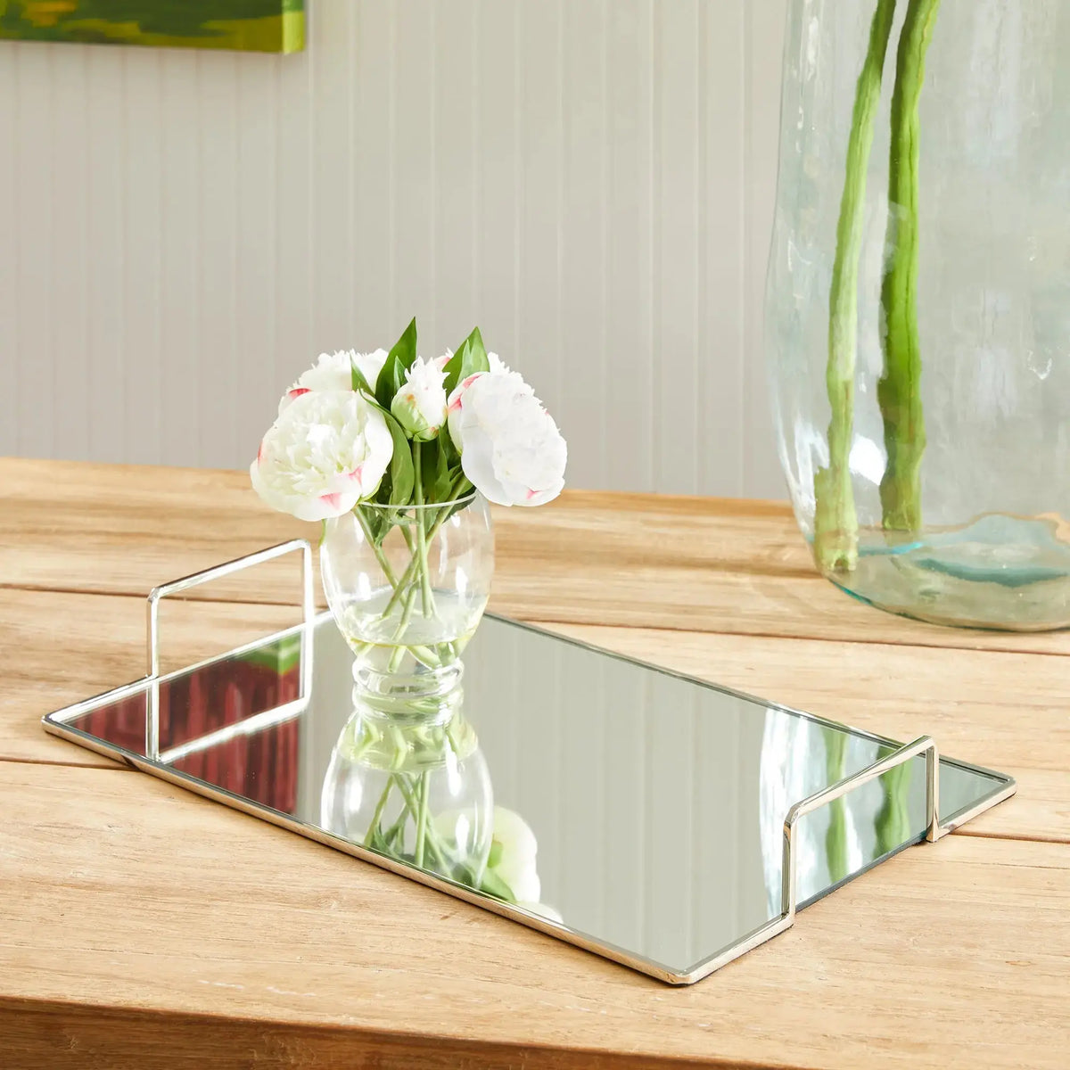 Covina large gold-tone tray styled with white flowers on a wood table
