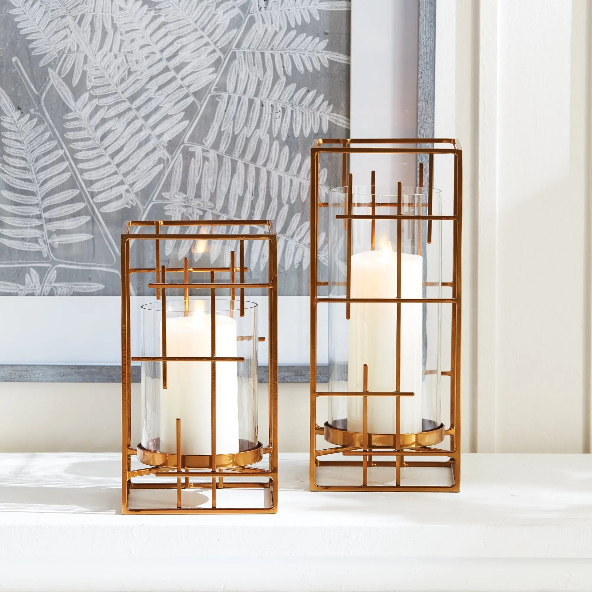 Geometric Gold Hurricane with Mondrian inspired iron lines and clear glass insert on a modern console – Villa Decor & Design