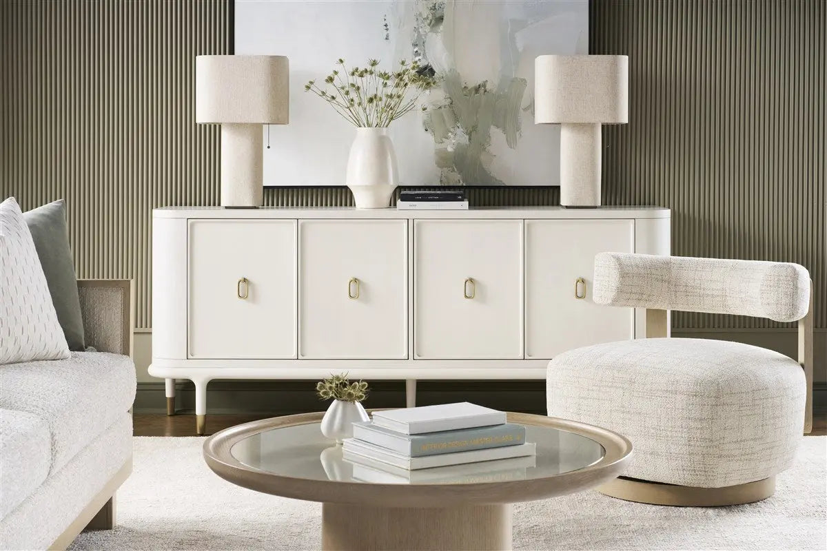 Daydream Swivel Chair, a modern, low-profile accent chair with a curved bolster back, upholstered in light Reynolds Linen fabric with exposed oak wood supports.