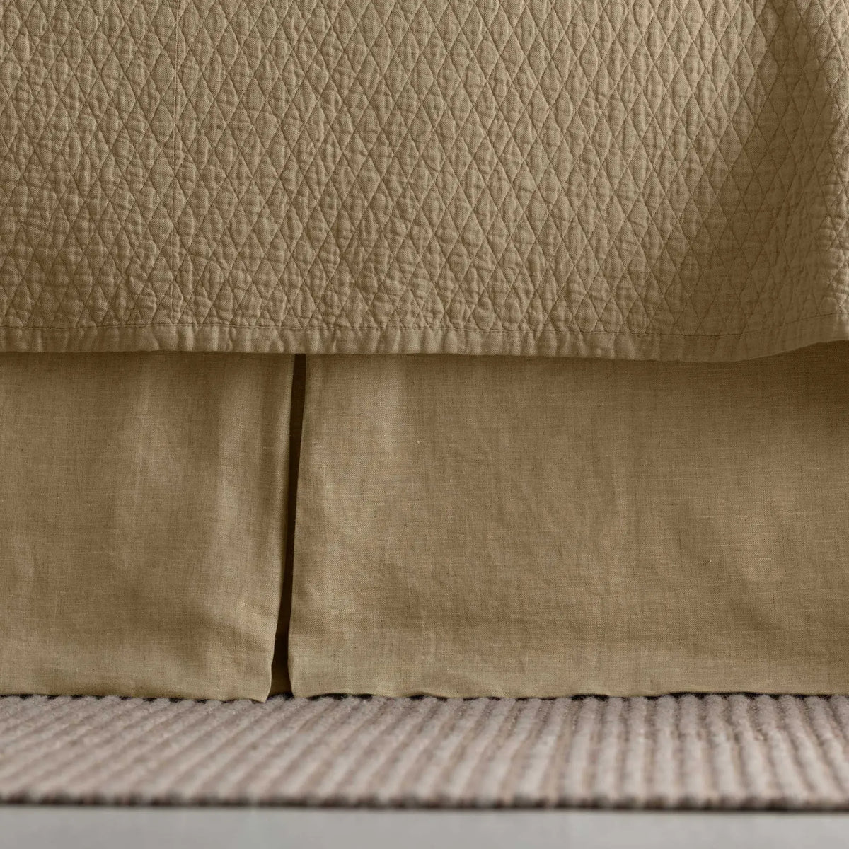 Dawn Tailored Bed Skirt in gold, close-up on a bed frame