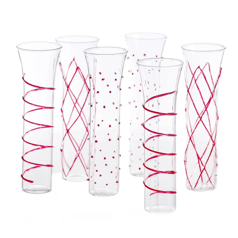 A set of six clear glass stemless champagne flutes with a geometric raised design.