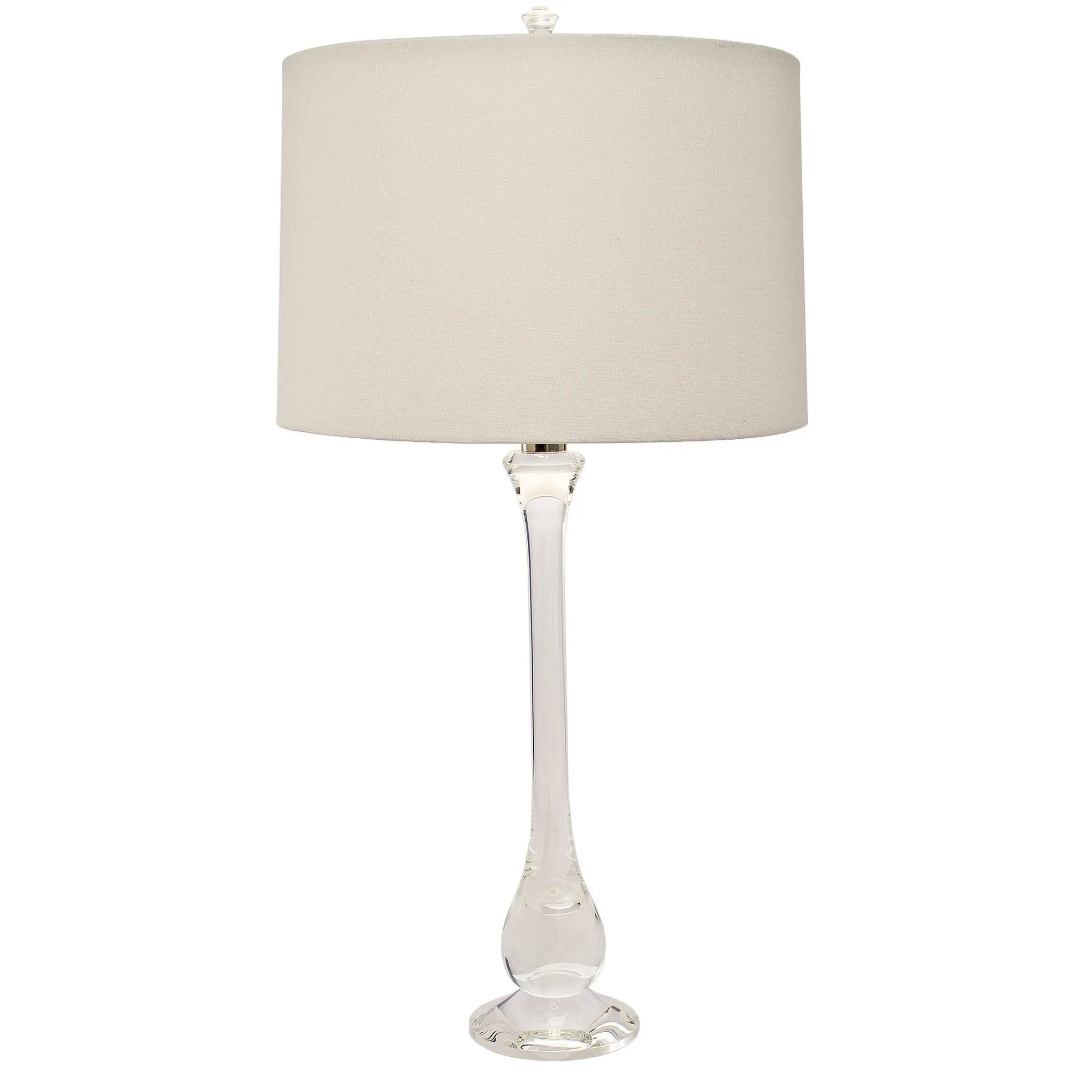 Ponte solid lead crystal table lamp with diamond-cut faceted base and cream-colored fabric drum shade, set on a console table.