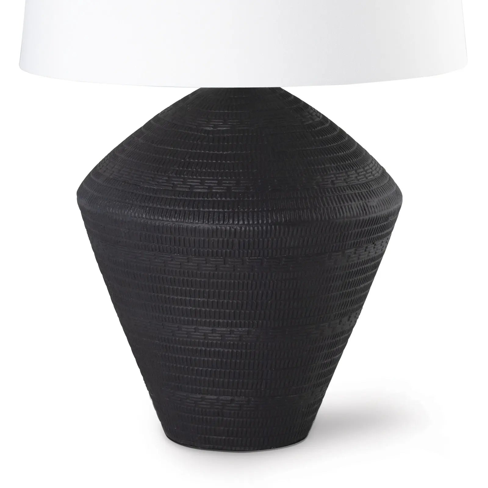 Black textured table lamp with a white lampshade on a white background