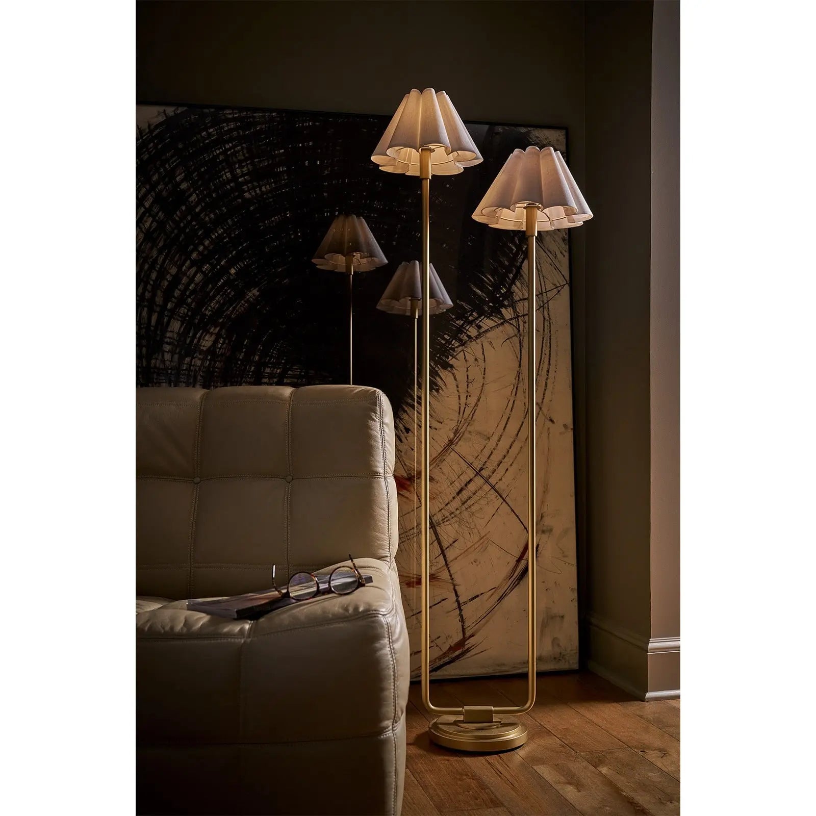 Modern floor lamps with unique lampshades in a dimly lit room.