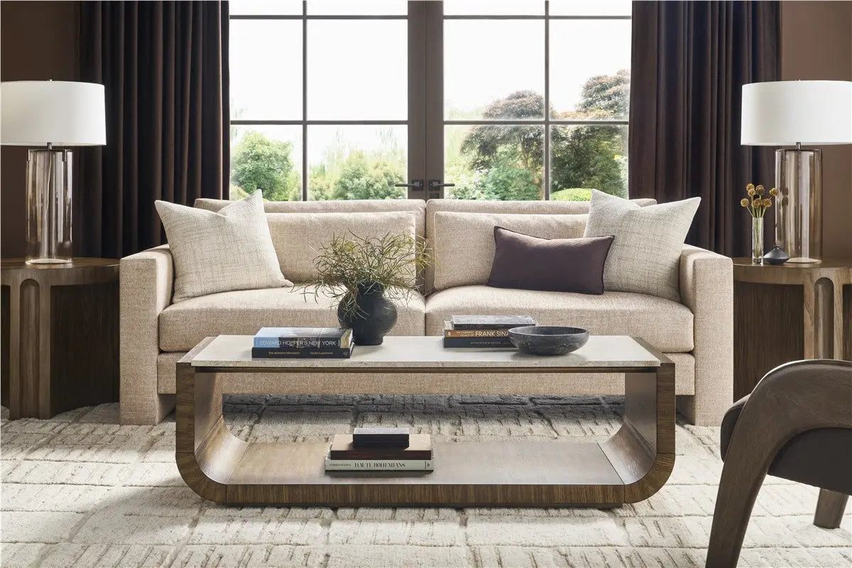 A modern 95-inch Brady Sofa with a unique suspended floating base and track arms, upholstered in textured light gray Jumpy Burlap performance fabric.