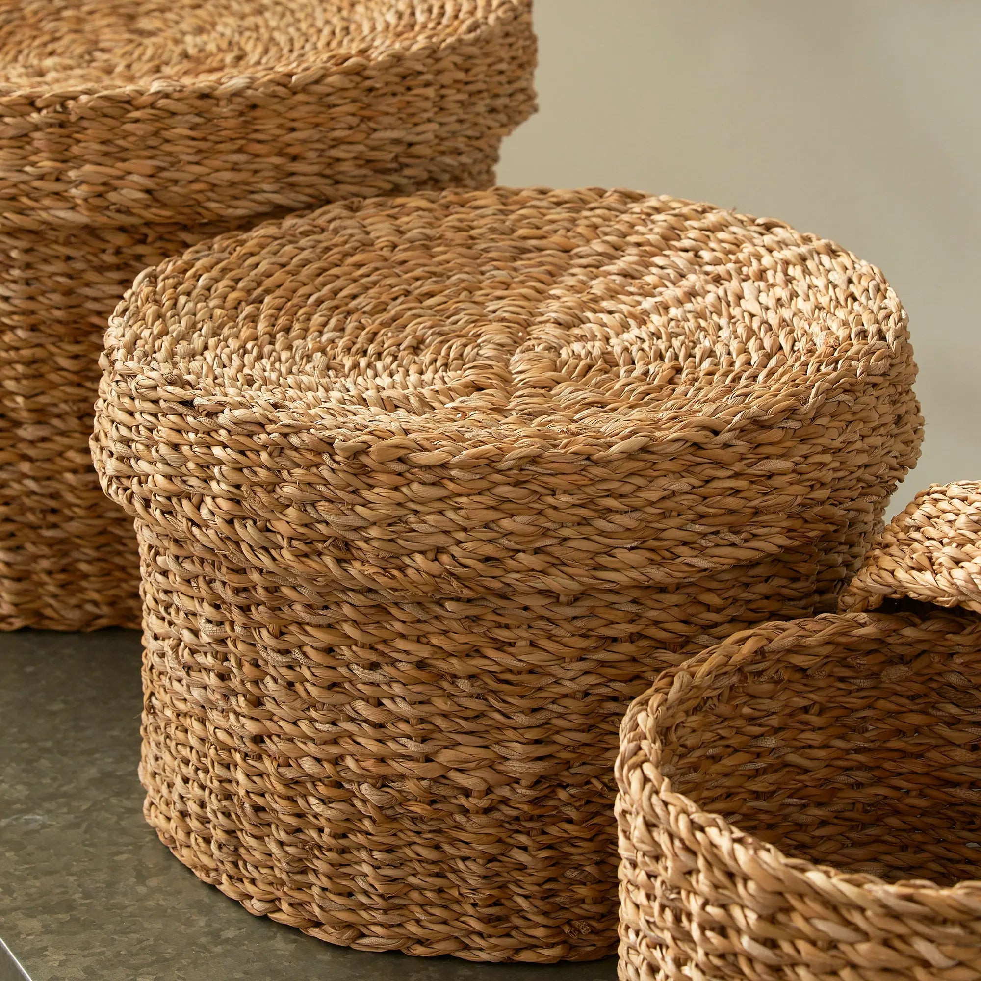 Woven jute baskets on a neutral background