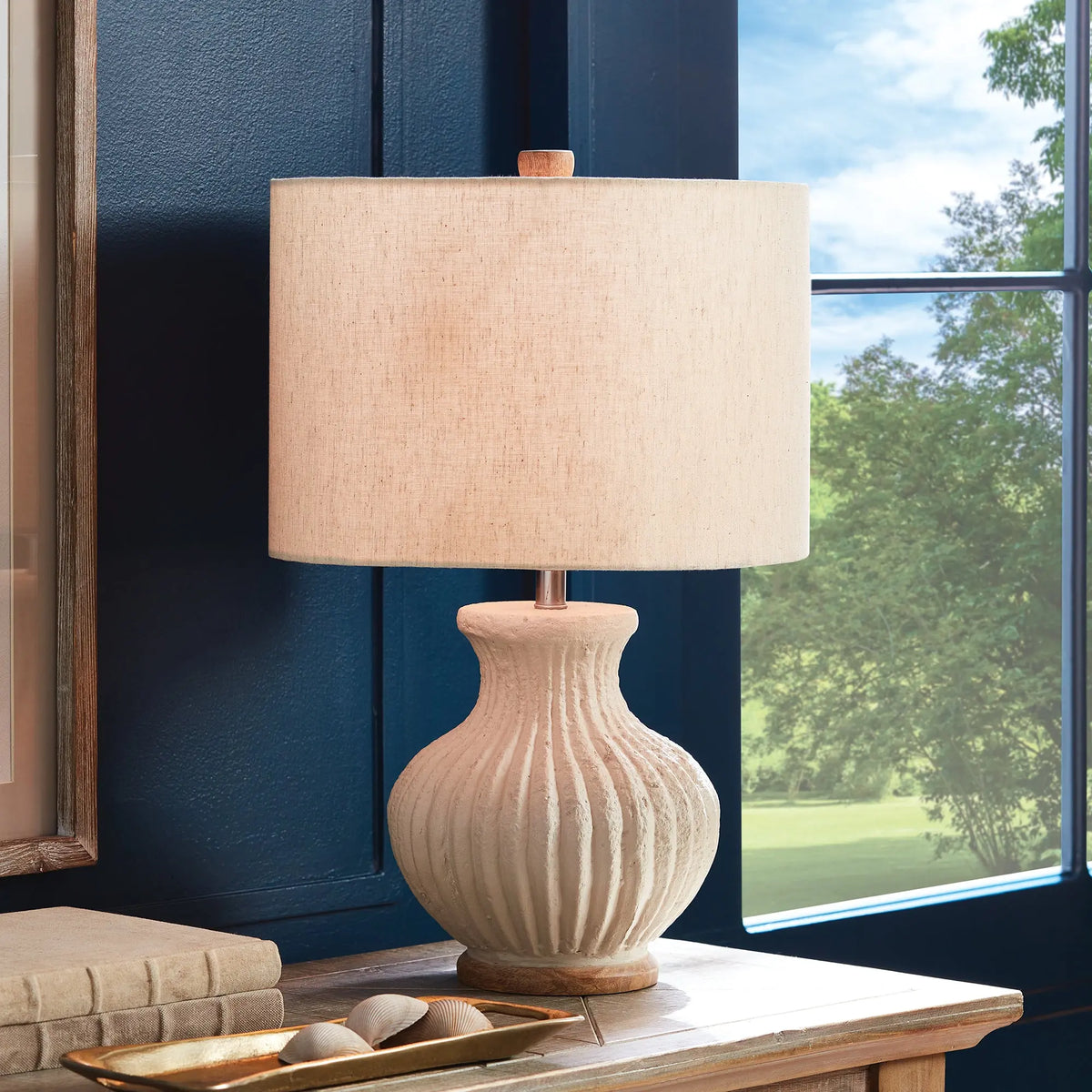 Margot lamp on a table in front of a window