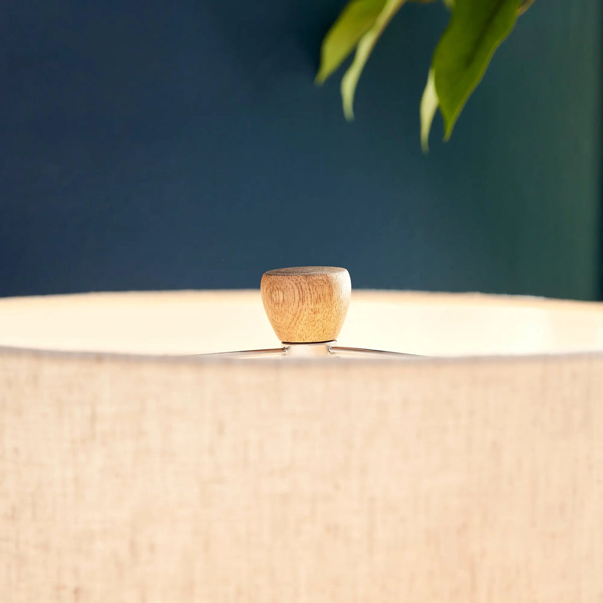 Close-up of the linen drum shade against a blue wall