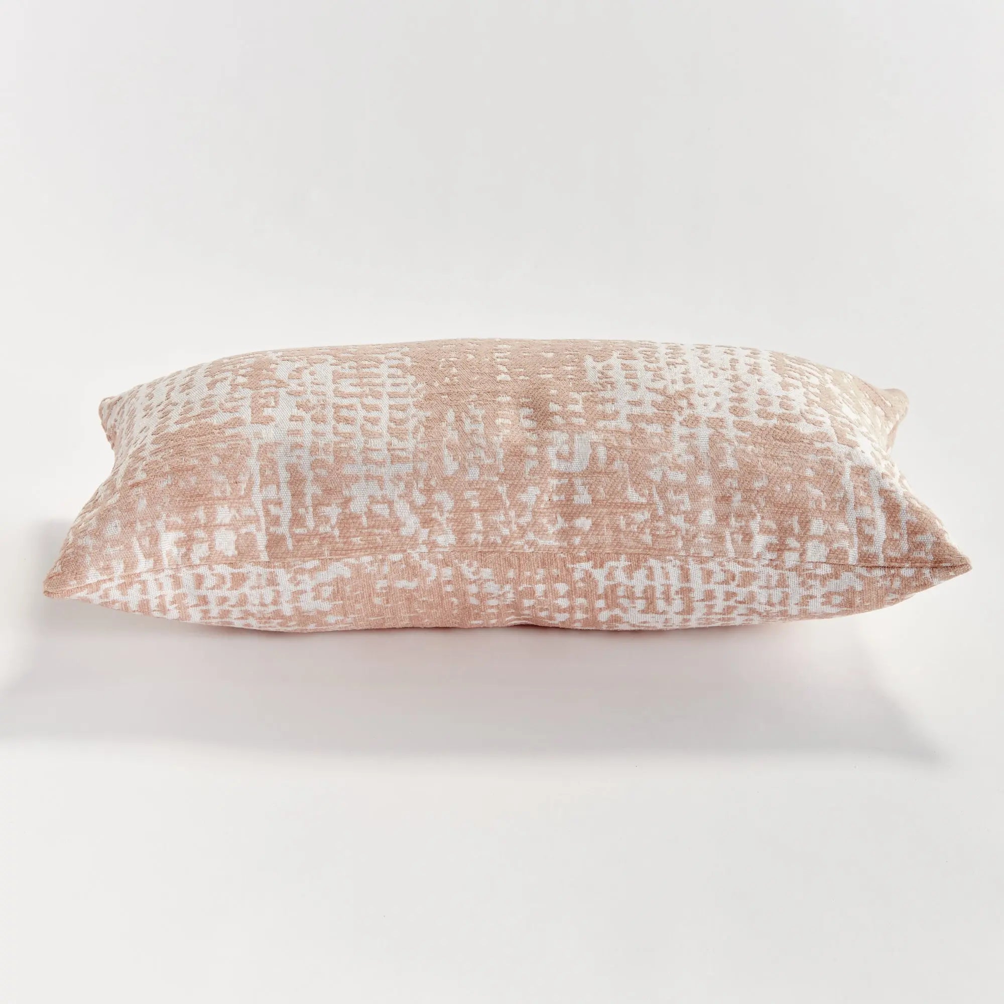 Blush Rectangular pillow with a textured pattern on a white background
