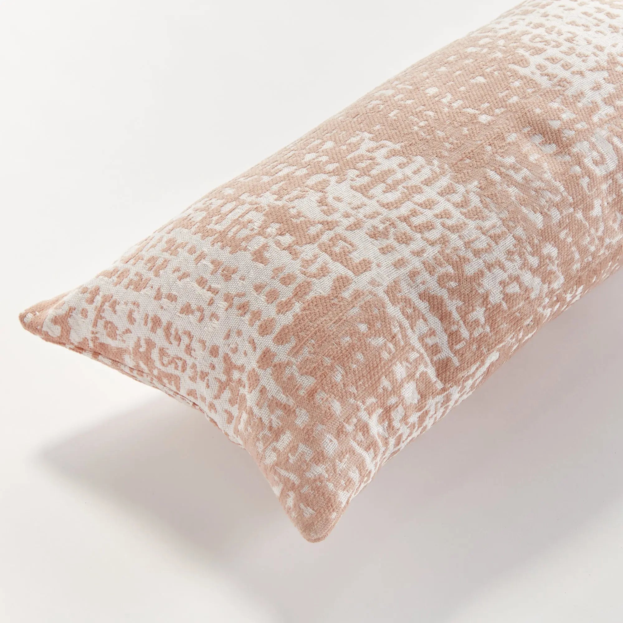Blush Rectangular pillow with a textured pattern on a white background