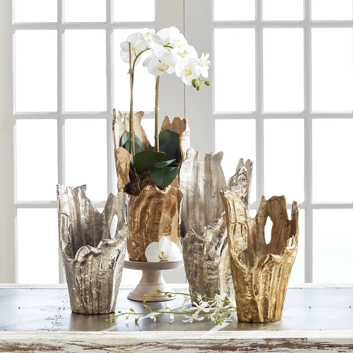 Arbre silver and gold vases styled together with orchids
