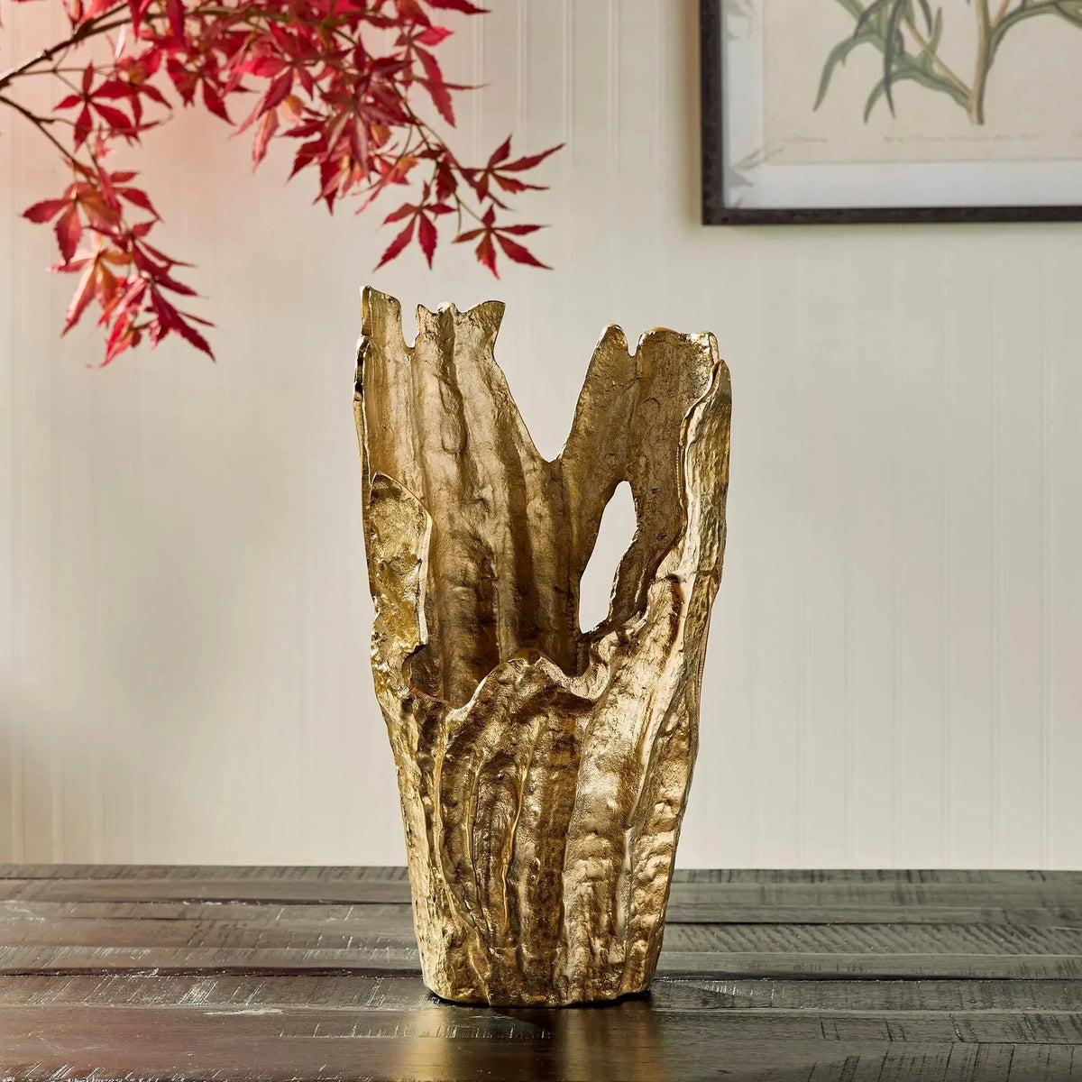 Arbre gold vase near red maple leaves