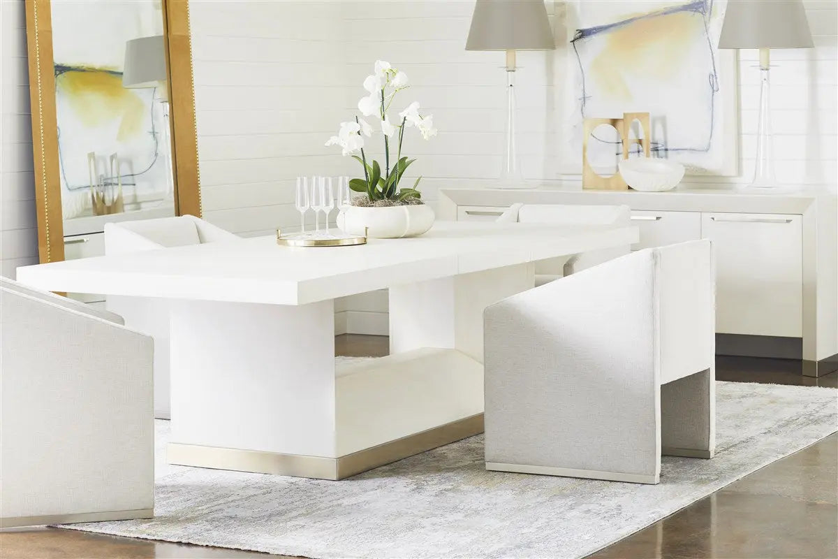 Dunecrest Dining Chair, an upholstered dining chair with arms, covered in light Nomad Snow fabric and featuring a modern Cava wood finish.