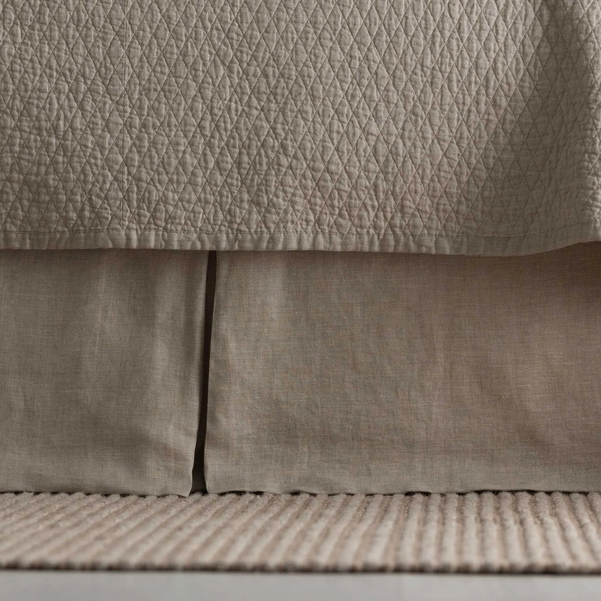 Dawn Tailored Bed Skirt in taupe, close-up on a bed frame
